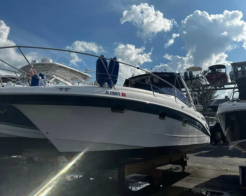 Slide: The Image of 2006 Four Winns 328 Vista boat docked under a sunny sky. - 5