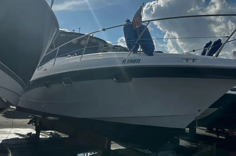 Slide: The Image of 2006 Four Winns 328 Vista boat on a trailer under a cloudy sky. - 6