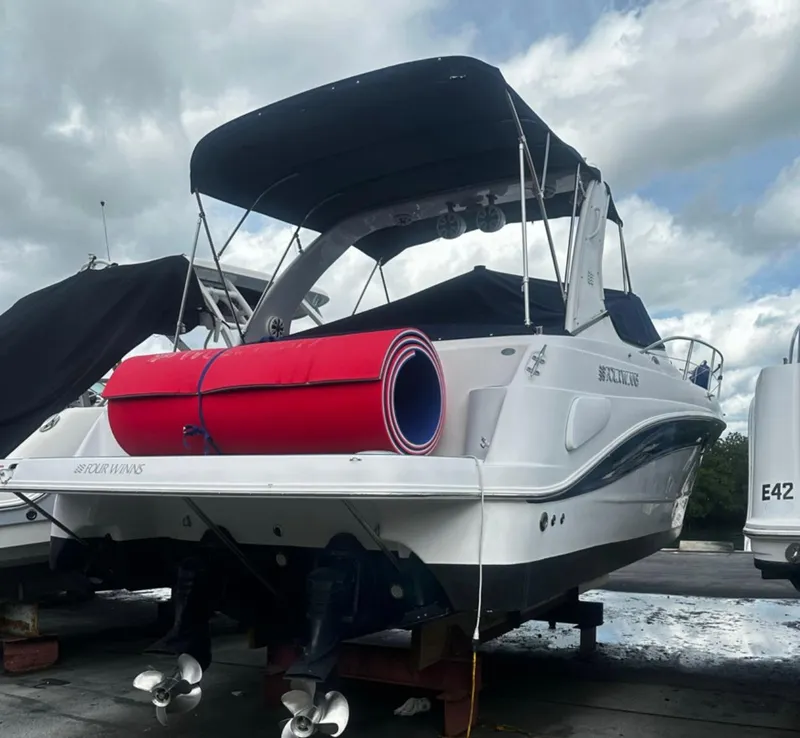 Slide: The Image of 2006 Four Winns 328 Vista boat with black canopy and red rolled mat. - 7