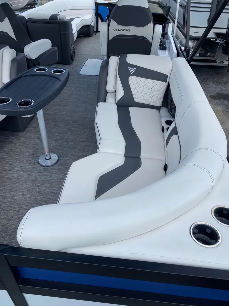 Slide: The Image of 2024 Viaggio Diamante 24U boat interior with white and gray seating and cup holders. - 26