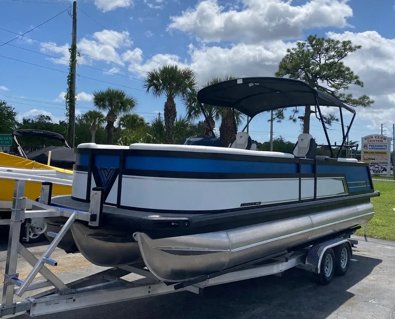 Slide: The Image of 2024 Viaggio Diamante 24U pontoon boat on a trailer under a sunny sky. - 3