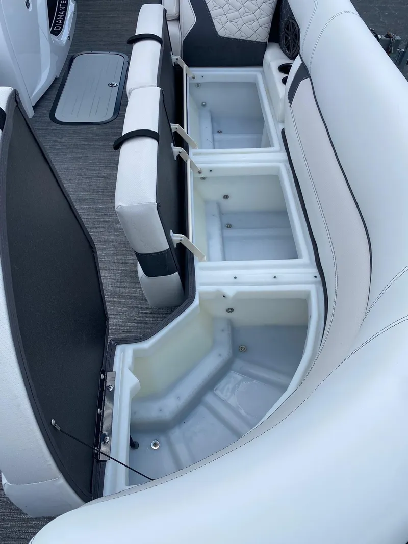 Slide: The Image of 2024 Viaggio Diamante 24U boat with open storage compartments and white cushioned seating. - 33