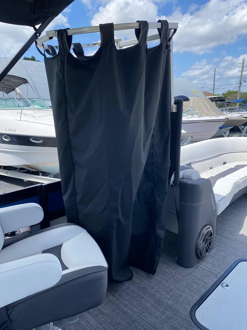 Slide: The Image of 2024 Viaggio Diamante 24U boat interior with privacy curtain and seating. - 39