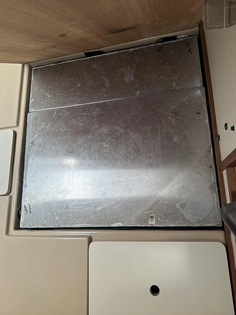 Slide: The Image of 1990 Island Packet 27 interior with metal panel and beige surfaces. - 19