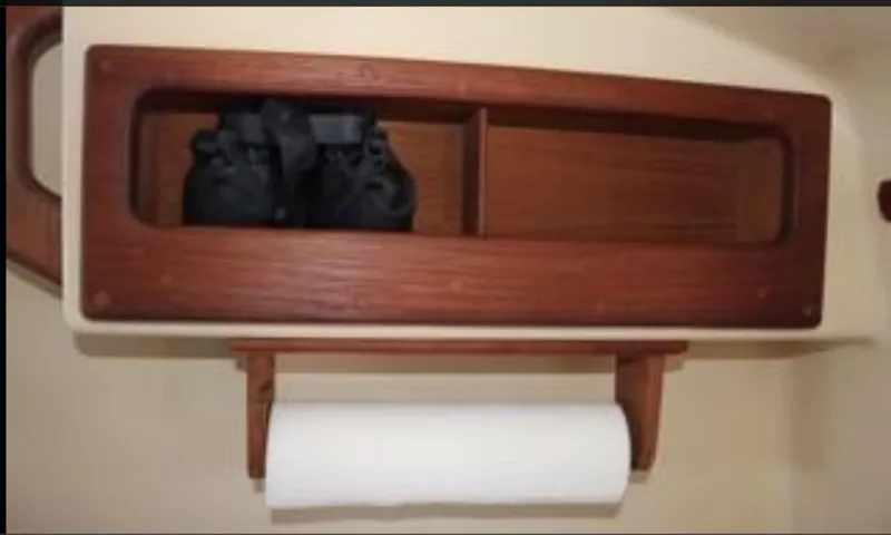 Slide: The Image of Wooden shelf and paper towel holder in 1990 Island Packet 27 boat interior. - 7