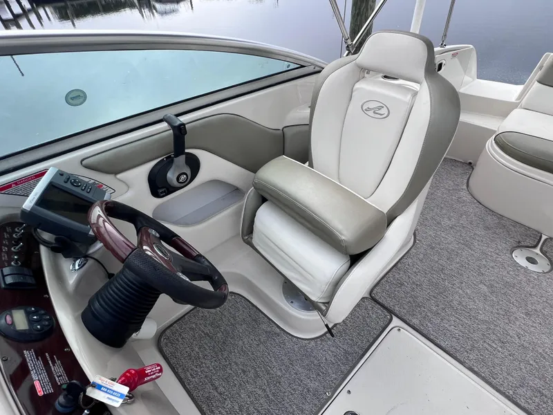 Slide: The Image of Interior of 2007 Sea Ray 240 Sundeck with 2023 motor, featuring captain's chair and dashboard. - 10