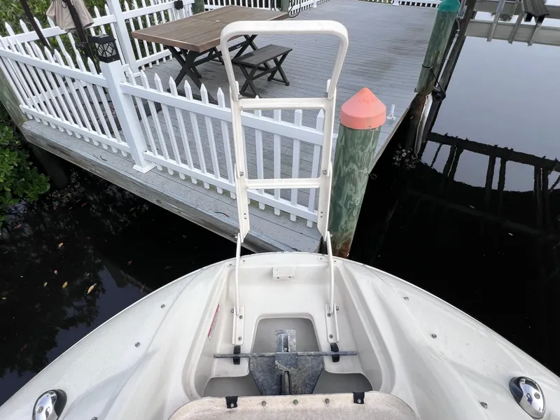 Slide: The Image of Bow of 2007 Sea Ray 240 Sundeck with 2023 motor, docked near white fence and deck. - 14