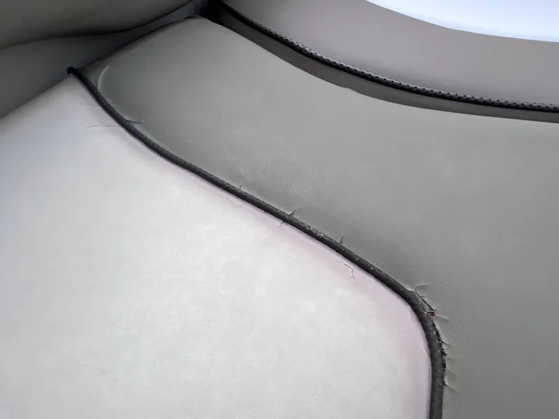 Slide: The Image of Close-up of worn upholstery on a 2007 Sea Ray 240 Sundeck boat seat. - 16
