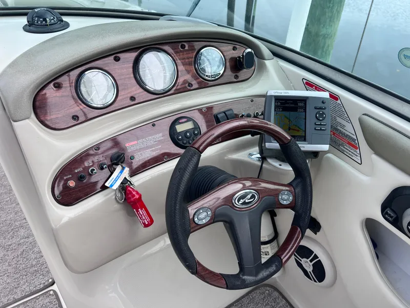 Slide: The Image of Sea Ray 240 Sundeck 2007 dashboard with modern navigation system and 2023 motor. - 18