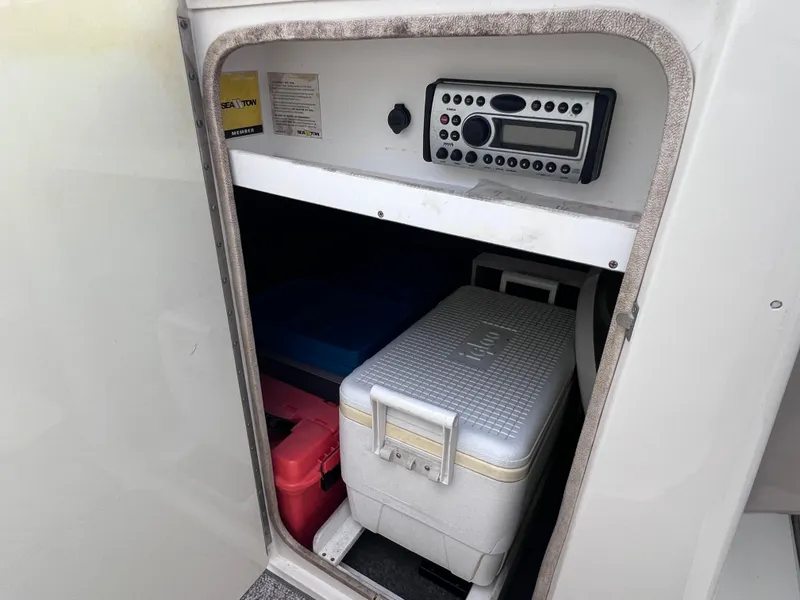 Slide: The Image of Storage compartment with coolers and radio on 2007 Sea Ray 240 Sundeck boat. - 23