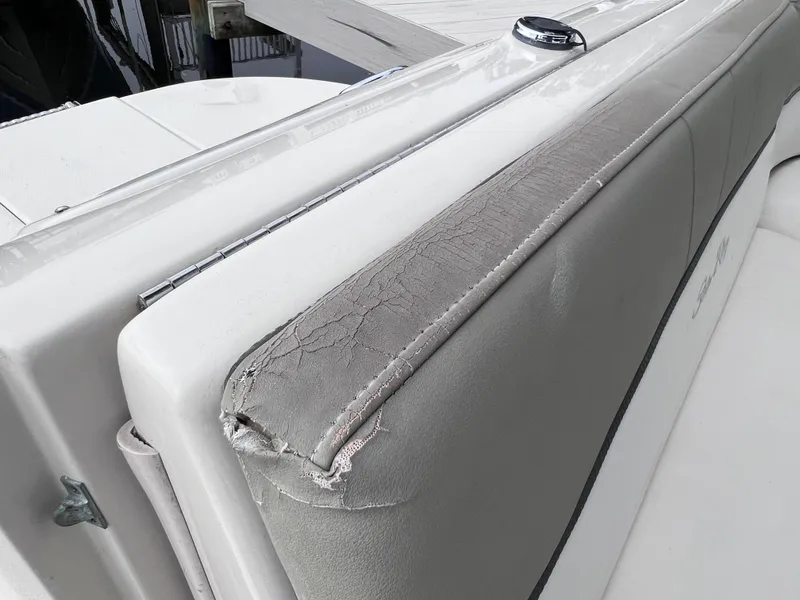 Slide: The Image of Close-up of worn upholstery on a 2007 Sea Ray 240 Sundeck boat. - 24