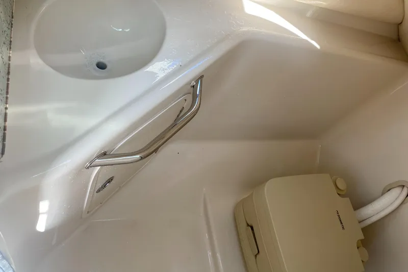 Slide: The Image of Interior of 2007 Sea Ray 240 Sundeck with sink and portable toilet. - 36