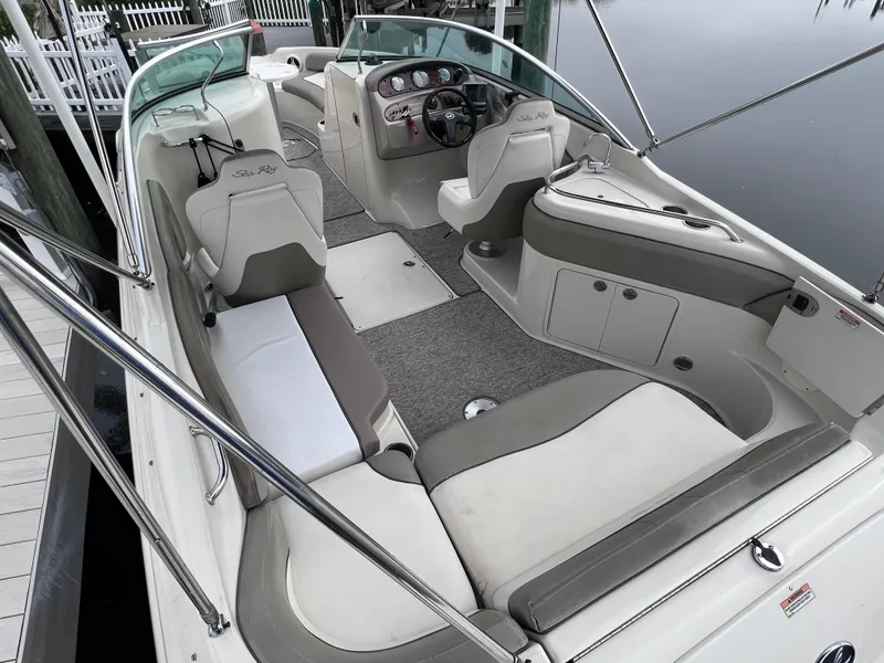 Slide: The Image of 2007 Sea Ray 240 Sundeck with 2023 motor, spacious seating, and modern dashboard. - 5