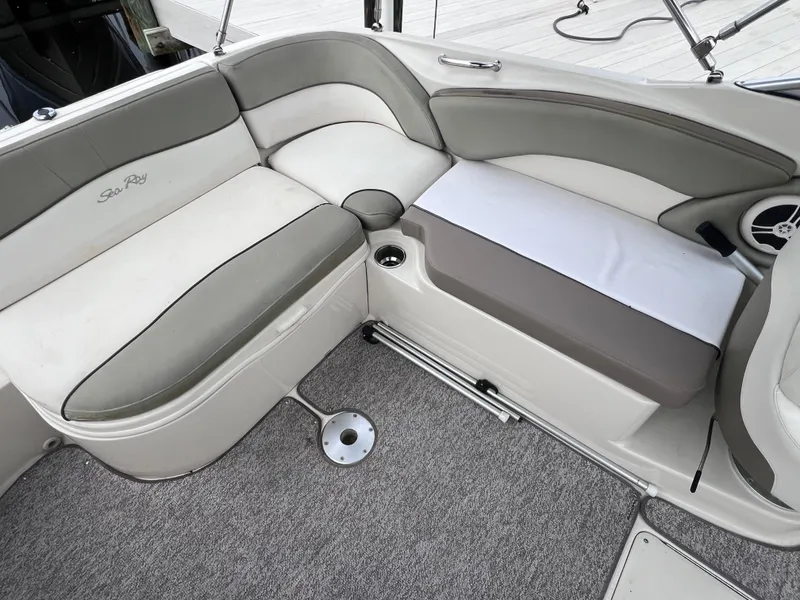 Slide: The Image of 2007 Sea Ray 240 Sundeck interior seating with 2023 motor, gray and white upholstery. - 6
