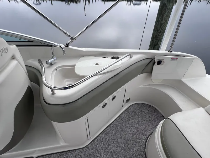 Slide: The Image of Interior view of 2007 Sea Ray 240 Sundeck with 2023 motor, featuring a sink and storage. - 7