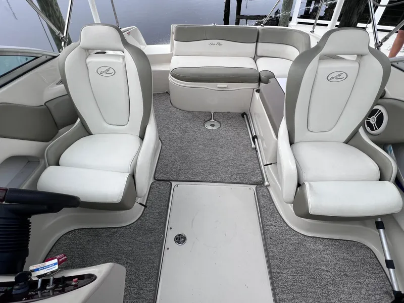 Slide: The Image of 2007 Sea Ray 240 Sundeck interior with 2023 motor, featuring plush seating. - 8