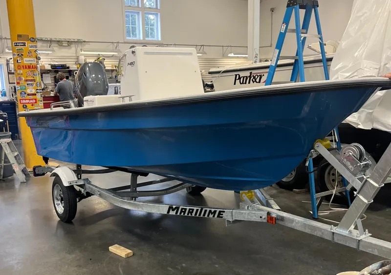 Slide: The Image of 2024 Maritime 1480 Skiff boat on trailer in workshop. - 2