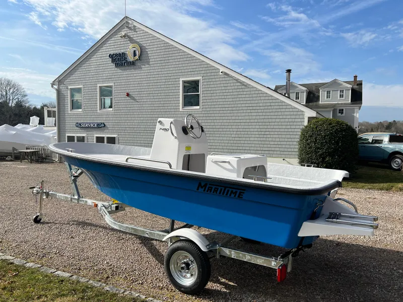 Slide: The Image of 2024 Maritime 1480 Skiff boat on trailer outside a marine dealership. - 7