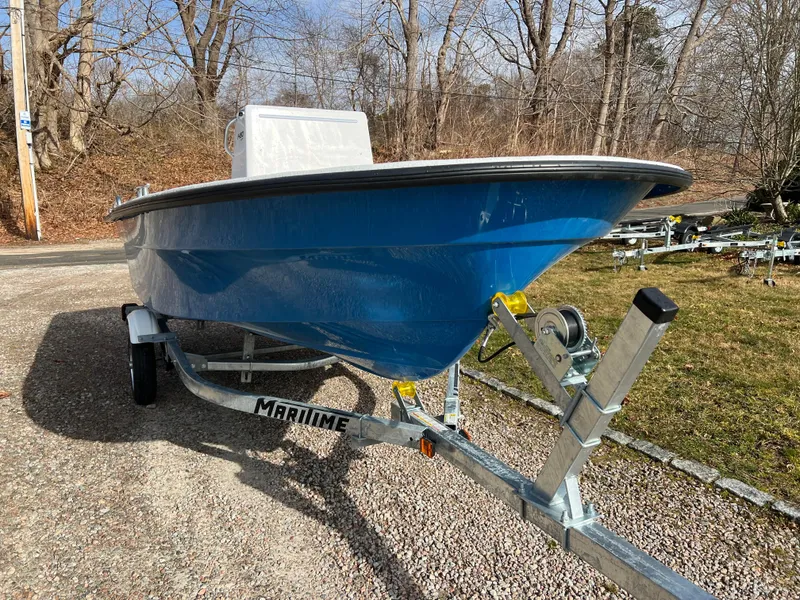 Slide: The Image of 2024 Maritime 1480 Skiff boat on a trailer in a wooded area. - 8