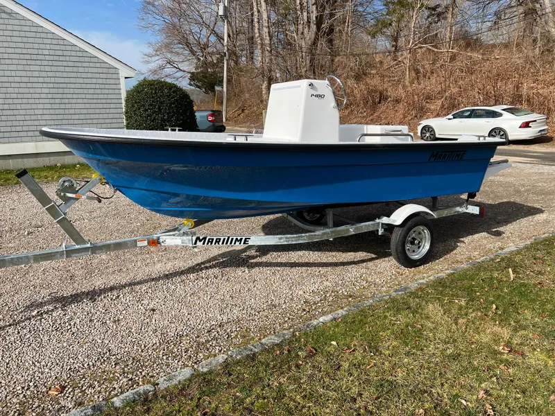 Slide: The Image of 2024 Maritime 1480 Skiff boat on a trailer in a driveway. - 9