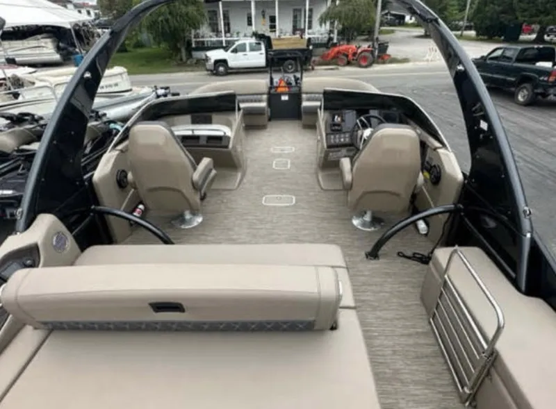Slide: The Image of 2022 Bennington 27 QX boat interior with beige seating and modern dashboard. - 2