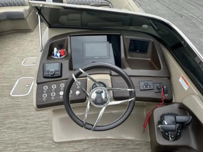 Slide: The Image of 2022 Bennington 27 QX boat dashboard with steering wheel and control panel. - 5