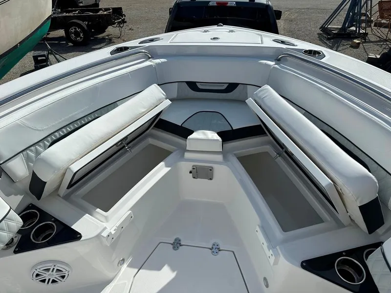 Slide: The Image of 2024 Blackfin 222CC boat interior with white cushioned seating and storage compartments. - 35