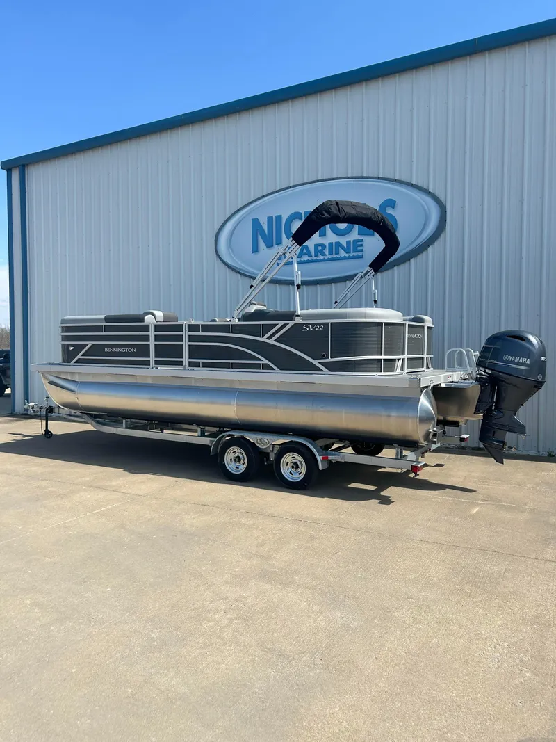 Slide: The Image of 2024 Bennington 22 SVSR pontoon boat outside Nichols Marine dealership. - 3