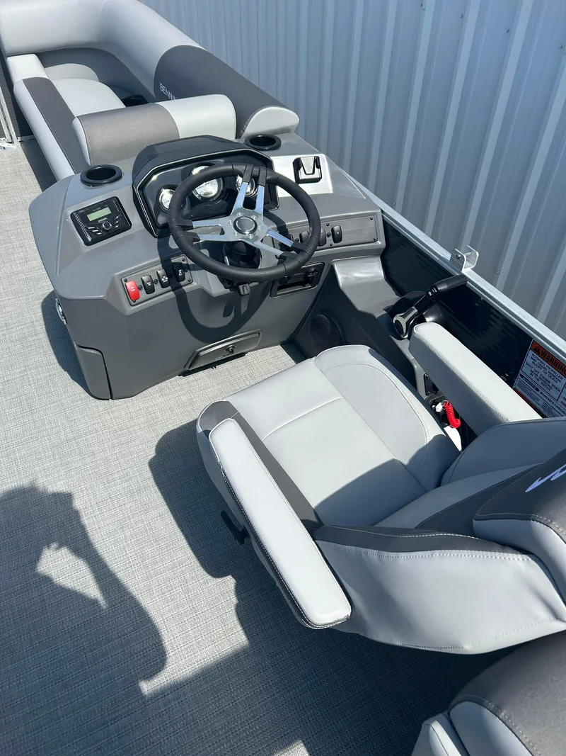 Slide: The Image of 2024 Bennington 22 SVSR boat cockpit with steering wheel and seating. - 8