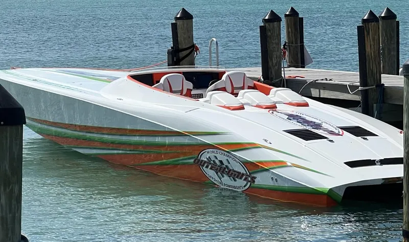 Slide: The Image of 2015 Outerlimits SL-50 speedboat docked in clear blue water. - 12