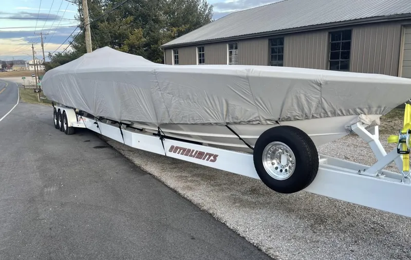 Slide: The Image of 2015 Outerlimits SL-50 boat covered on a trailer. - 13