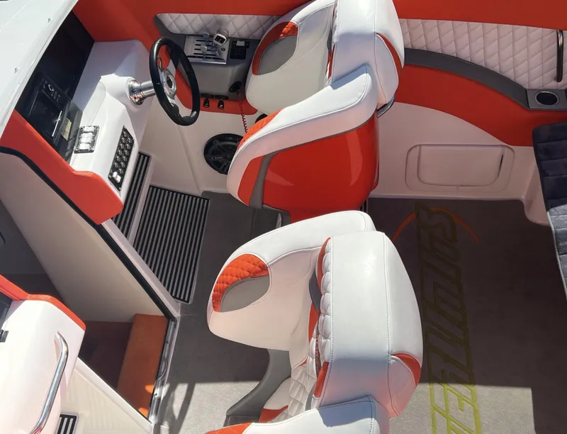 Slide: The Image of 2015 Outerlimits SL-50 boat interior with red and white seating and steering console. - 22