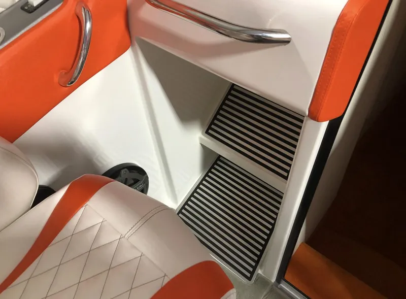 Slide: The Image of 2015 Outerlimits SL-50 boat interior with orange and white seating and striped steps. - 29