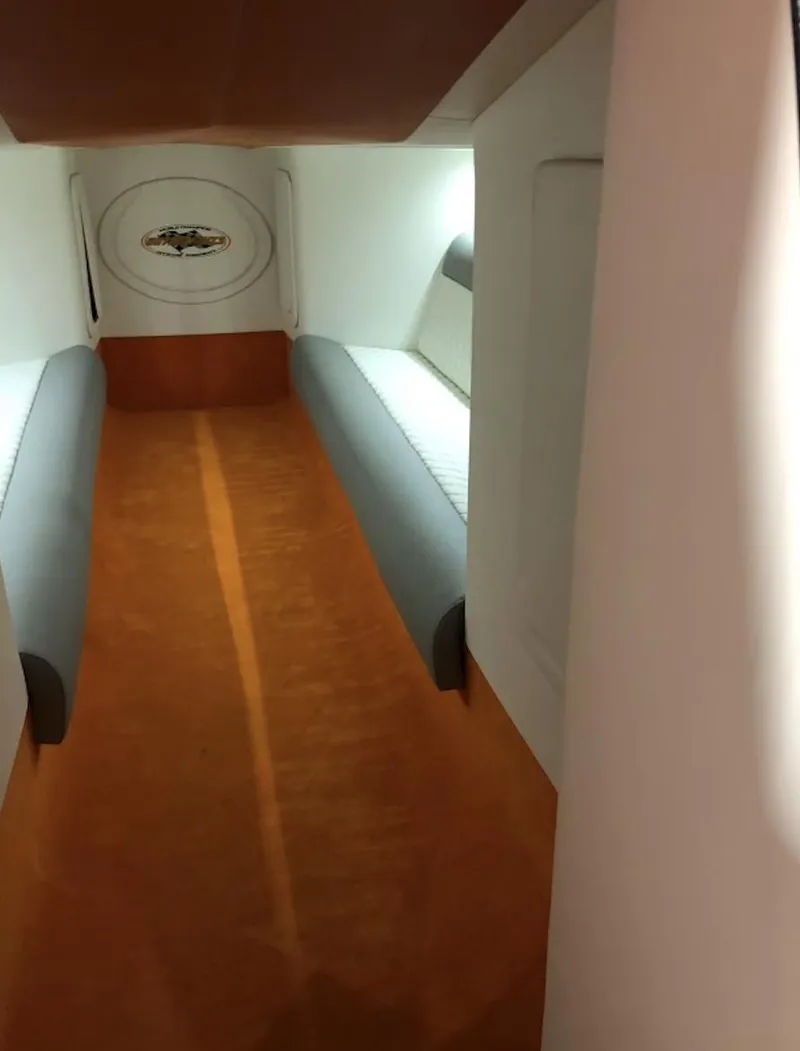 Slide: The Image of Interior cabin of a 2015 Outerlimits SL-50 boat with orange carpet and white seating. - 33