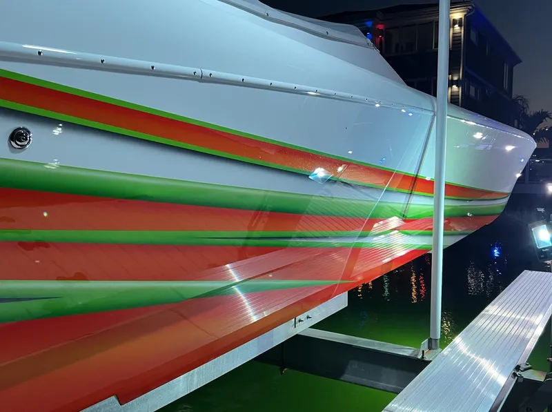 Slide: The Image of 2015 Outerlimits SL-50 boat with vibrant red and green stripes on the hull. - 7