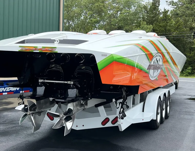 Slide: The Image of 2015 Outerlimits SL-50 powerboat on a trailer, rear view with vibrant graphics. - 8