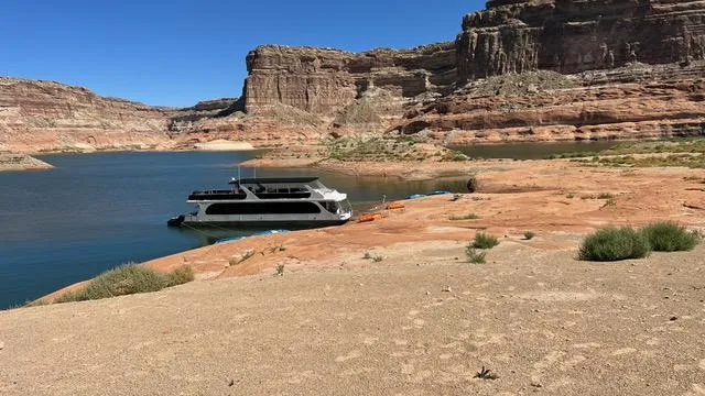 Slide: The Image of Houseboat on serene lake with rocky cliffs, Bravada Dream Weaver 2011 model. - 0