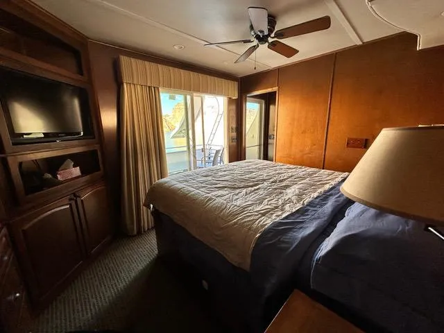 Slide: The Image of Bravada Dream Weaver 2011 boat navigating scenic lake with rocky shoreline and cloudy sky. - 15