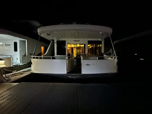 Slide: The Image of Luxurious kitchen interior of 2011 Bravada Dreamweaver Share #14 with wicker chairs and stainless steel fridge. - 2