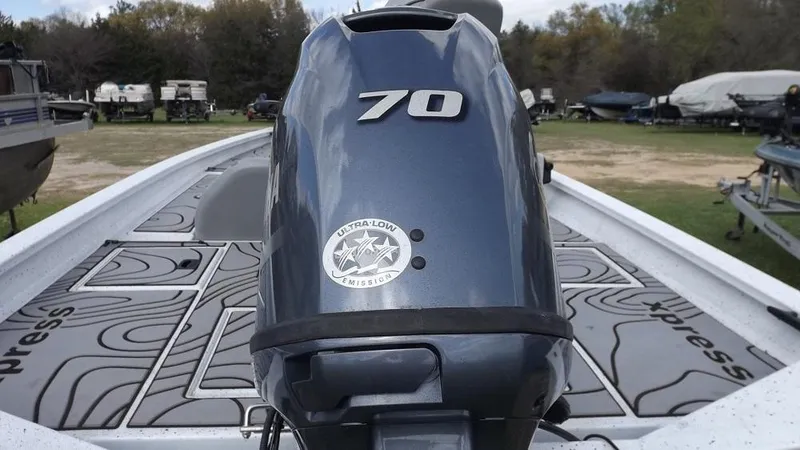Slide: The Image of 2021 Xpress XP7 boat with a 70 HP outboard motor in a boatyard. - 14