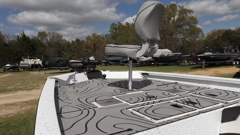 Slide: The Image of 2021 Xpress XP7 boat with a raised seat and patterned deck, parked outdoors. - 7