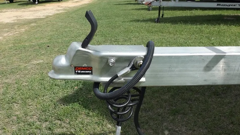 Slide: The Image of Trailer hitch of a 2021 Xpress XP7 boat on grass. - 9