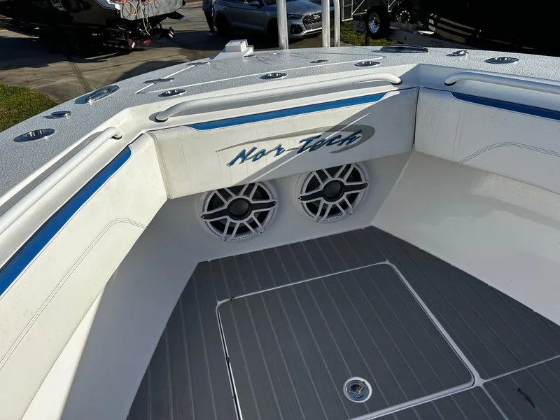 Slide: The Image of 2022 Nor-Tech 392 Superfish boat interior with speakers and logo. - 11