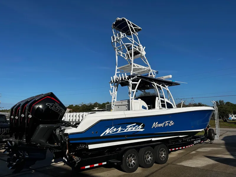 Slide: The Image of 2022 Nor-Tech 392 Superfish boat with triple outboard engines on a trailer. - 2