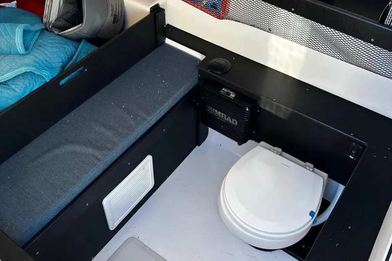 Slide: The Image of 2022 Nor-Tech 392 Superfish cabin interior with toilet and seating area. - 22