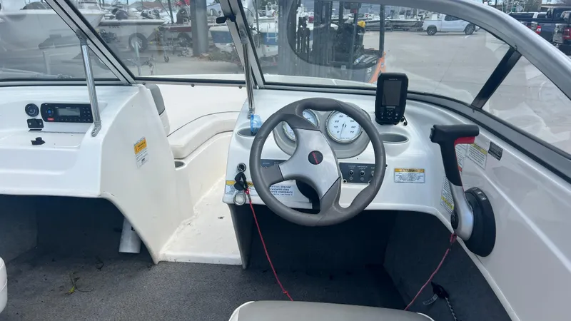 Slide: The Image of 2012 Bayliner 175 Bowrider boat cockpit with steering wheel and control panel. - 13