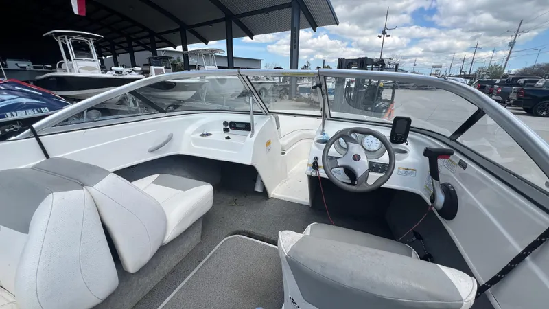 Slide: The Image of 2012 Bayliner 175 Bowrider interior view with steering wheel and seating. - 14