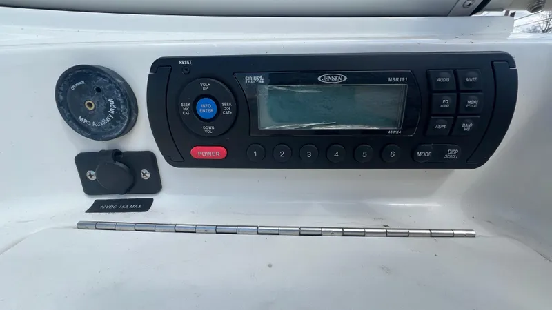 Slide: The Image of Bayliner 175 Bowrider 2012 dashboard with Jensen stereo system and power outlet. - 16