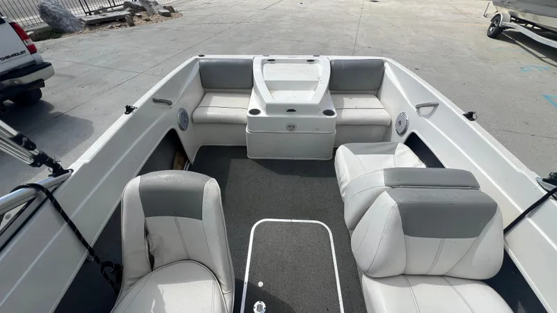 Slide: The Image of 2012 Bayliner 175 Bowrider interior with gray and white seating, spacious layout. - 17