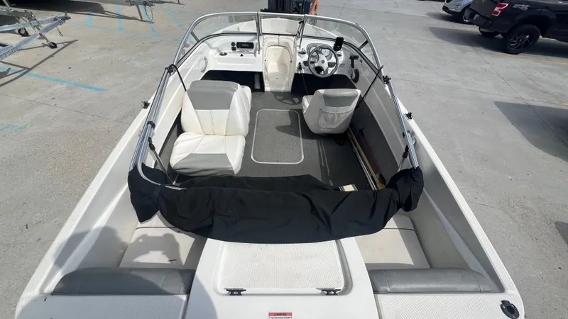 Slide: The Image of 2012 Bayliner 175 Bowrider interior view with seating and steering wheel. - 18